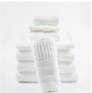 Stack of white piano key border hotel towels